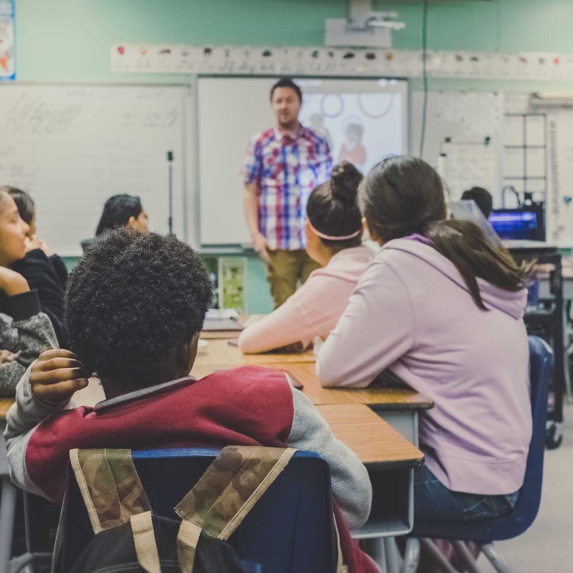 Teacher standing in front of his class
